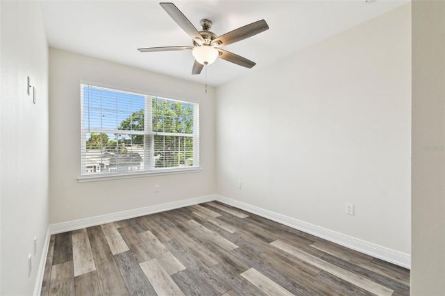 Bedroom 3 - fresh paint, ceiling fan, blinds and large window overlooking front of home. | Image 28