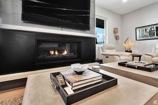Living area with a glass covered fireplace | Image 39