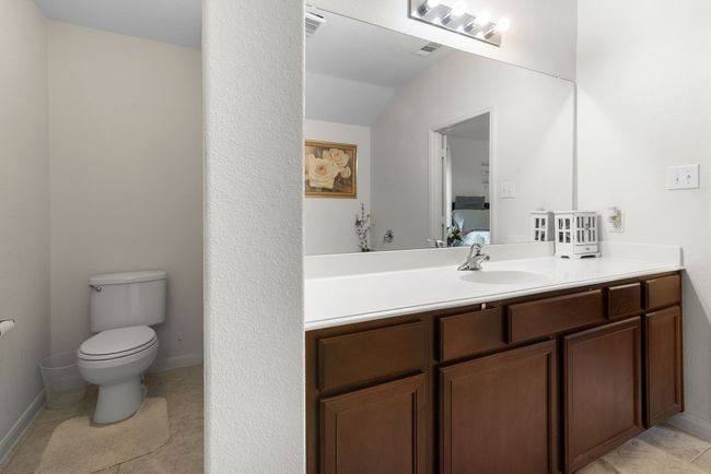 Bathroom with ensuite bathroom, vanity, baseboards, toilet, and lofted ceiling | Image 30