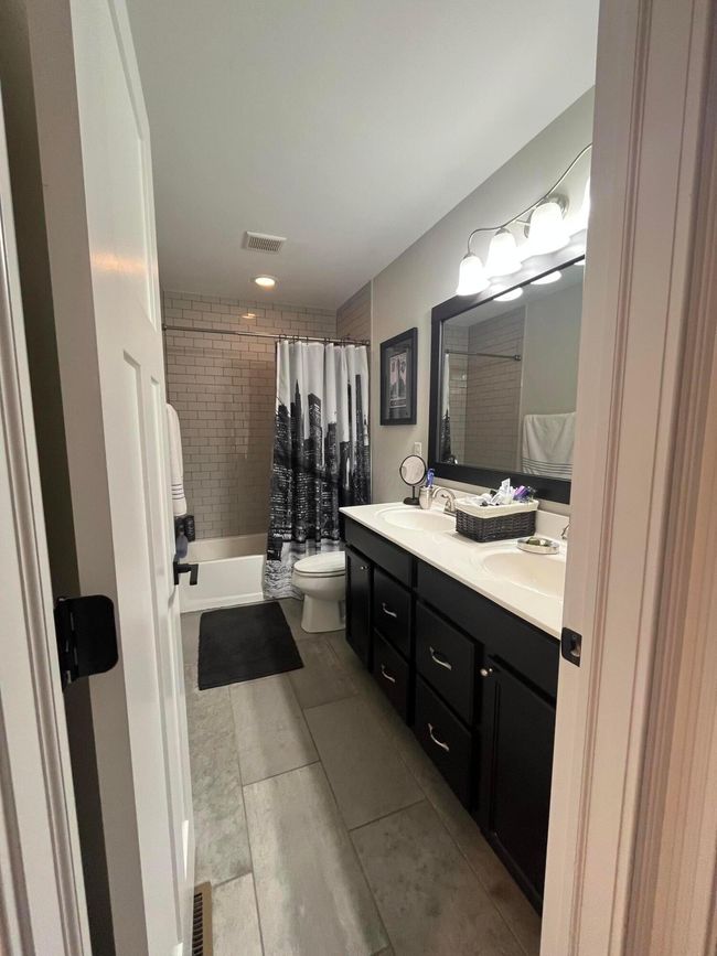 Subway tile shower and upgraded flooring, dual vanity | Image 22