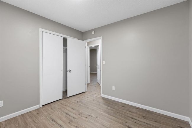 Unfurnished bedroom with light wood-style flooring, a closet, and baseboards | Image 13