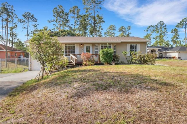 Long paved driveway giving you ample parking space, 1 car garage, fenced in yard, wood deck in front and back! | Image 30