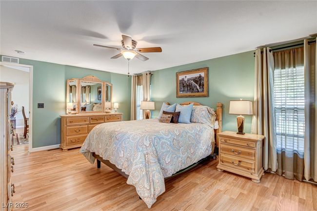 Bedroom with light wood-style floors and a ceiling fan | Image 27