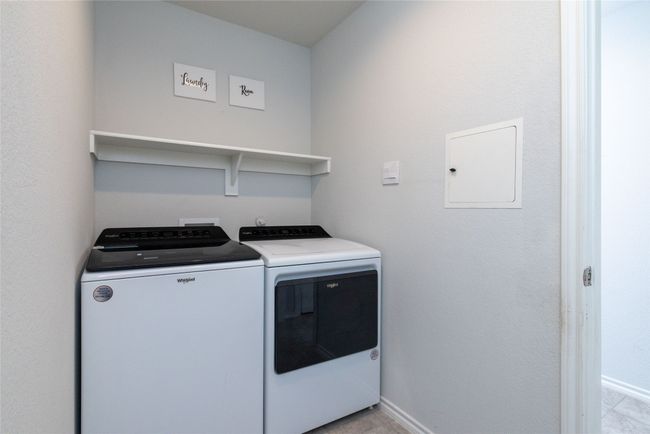 Laundry room featuring washing machine and dryer, baseboards, and light tile patterned floors | Image 33