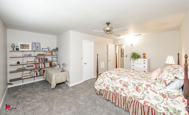 Carpeted bedroom featuring baseboards, visible vents, and a ceiling fan | Image 18