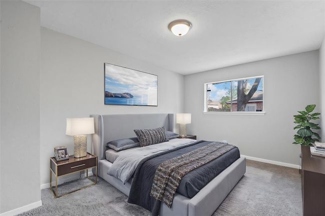 This spacious secondary bedroom features a large window that fills the room with natural light, creating a bright and inviting atmosphere. With ample closet space providing convenient storage for everyday living. | Image 30