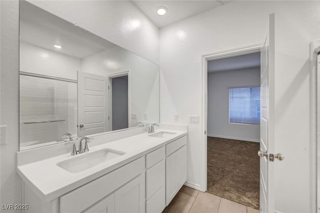 Bathroom featuring tile patterned floors, baseboards, double vanity, and a sink | Image 35