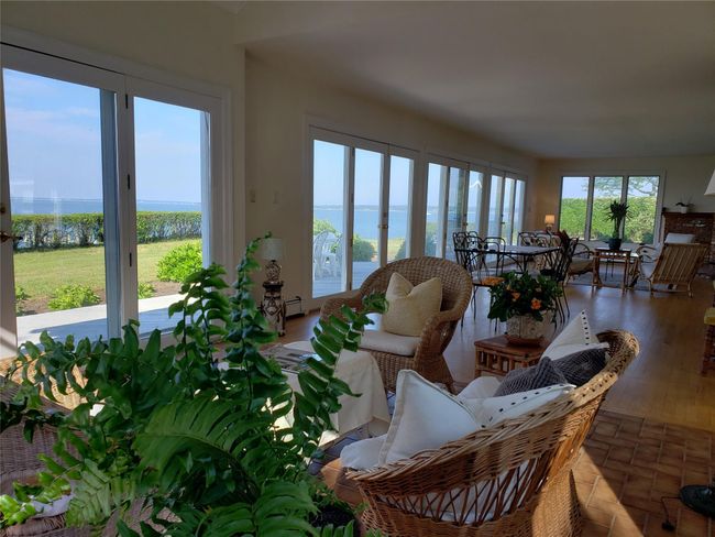 Sunroom / solarium featuring a water view and baseboard heating | Image 16