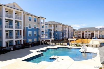 View of swimming pool with a patio area | Image 2