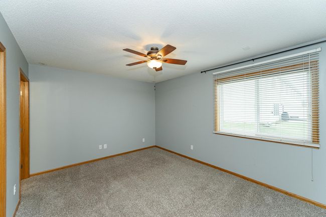 Primary bedroom with walk-in closet and three-quarter bath. | Image 9
