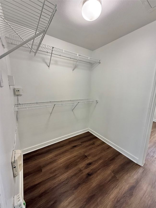 Spacious closet featuring wood finished floors | Image 13