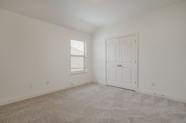 Unfurnished bedroom with vaulted ceiling and light colored carpet | Image 21