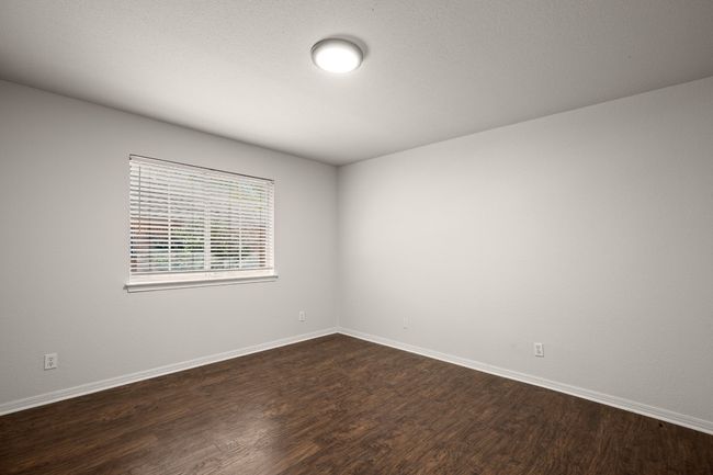 Unfurnished room featuring dark wood-style flooring and baseboards | Image 24