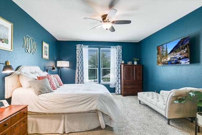 Carpeted bedroom featuring a textured wall and ceiling fan | Image 14