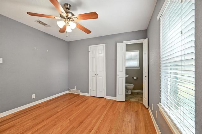 Kitchen with a peninsula, crown molding, ceiling fan, light tile patterned floors, and a textured wall | Image 27