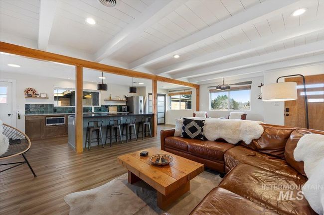 Living room featuring wood finished floors, beamed ceiling, and recessed lighting | Image 7