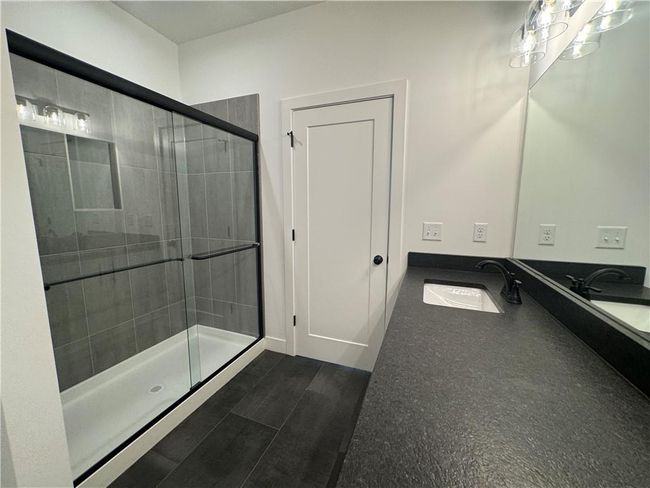 Full bathroom featuring a sink, a stall shower, and wood finished floors | Image 19