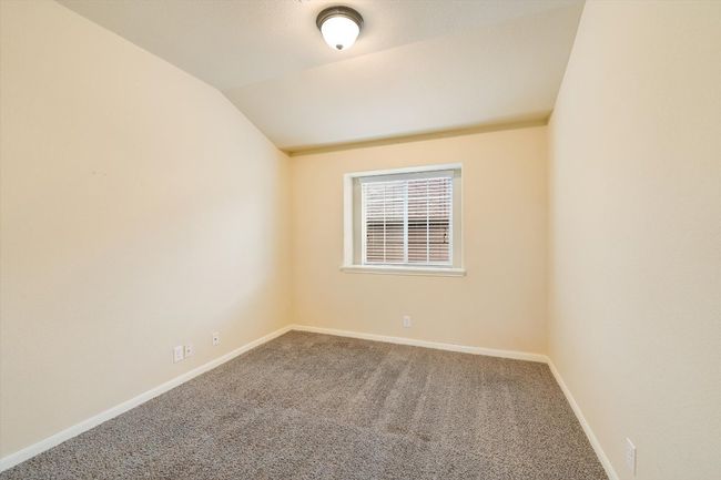 Unfurnished room with carpet flooring and vaulted ceiling | Image 12