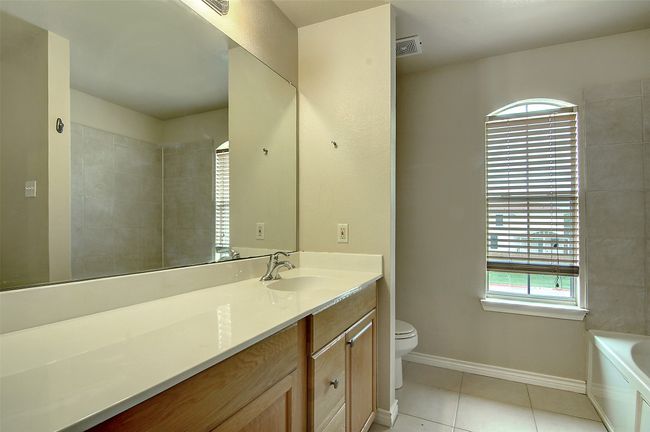Bathroom featuring vanity, toilet, and tile patterned flooring | Image 14