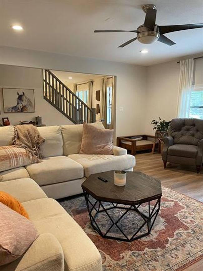 Living room with wood-style floors, a ceiling fan, stairway, and recessed lighting | Image 9