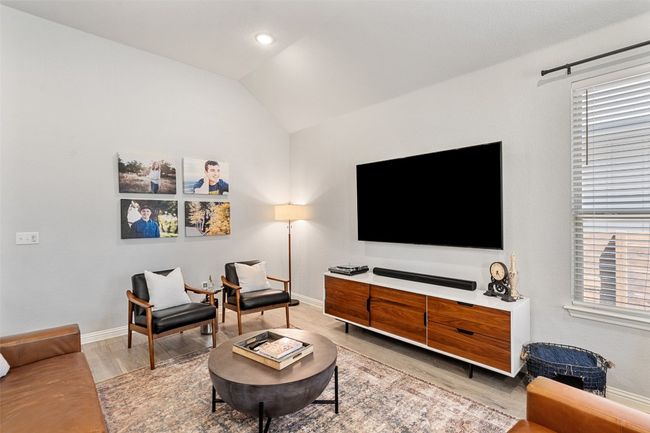 Living room featuring wood finished floors, vaulted ceiling, and recessed lighting | Image 7