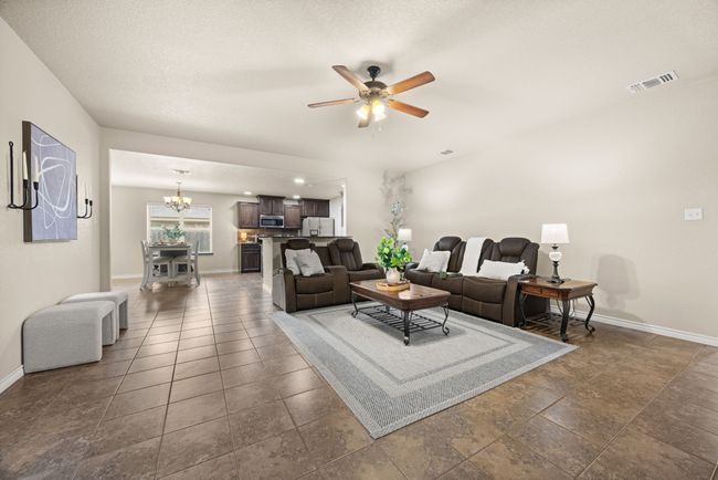 Living area featuring a chandelier and ceiling fan | Image 8