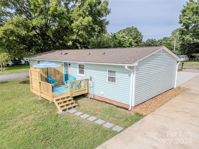 Rear view of cottage, featuring stepping stones to the driveway! | Image 38
