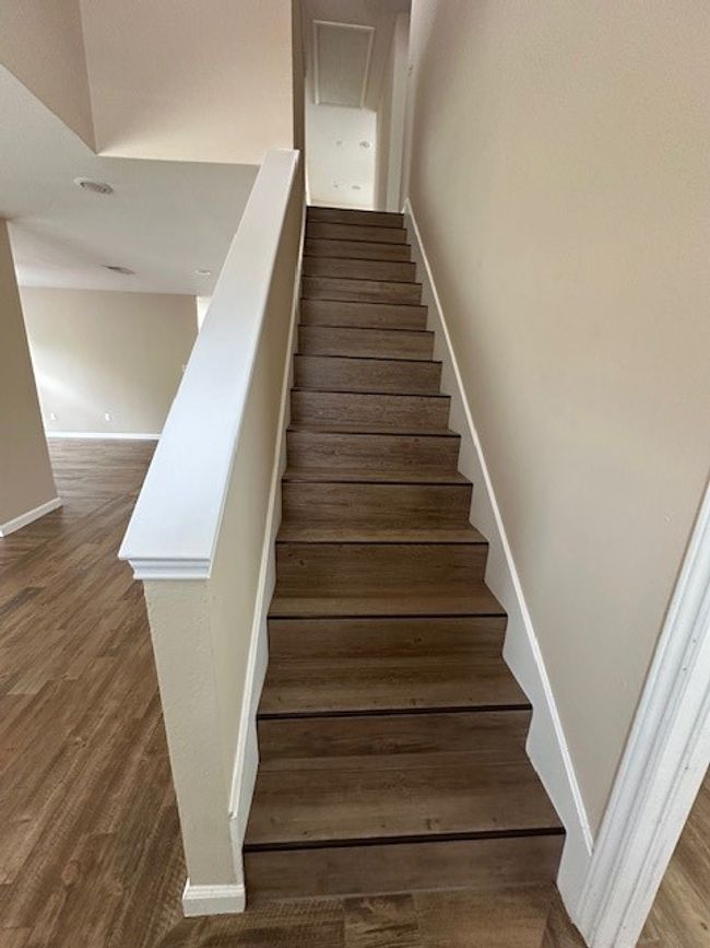 Stairway with baseboards and wood finished floors | Image 11