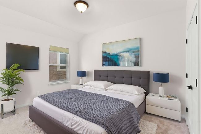 Bedroom featuring lofted ceiling, carpet flooring, and baseboards | Image 11