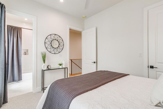 Bedroom with light colored carpet, baseboards, and a ceiling fan | Image 25