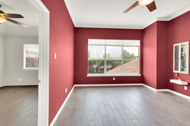 Unfurnished room with ornamental molding, wood finished floors, and ceiling fan | Image 19