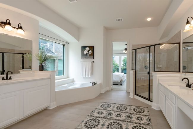 Bathroom with a garden tub, two vanities, a shower stall, ceiling fan, and recessed lighting | Image 19