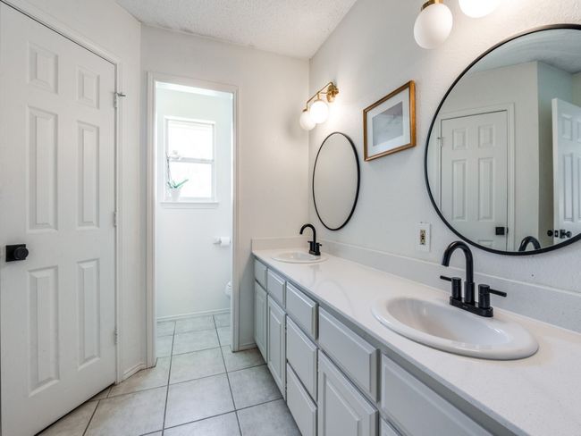 Bathroom featuring double vanity, a textured ceiling, and tile patterned floors | Image 18