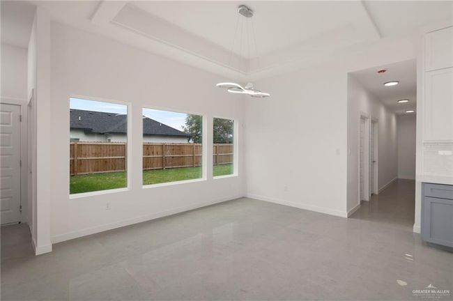 Unfurnished dining area with baseboards and a chandelier | Image 5