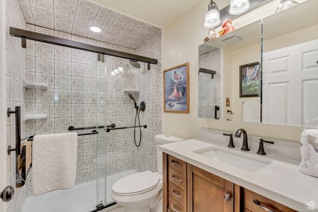 Full bath featuring a shower stall, toilet, and vanity | Image 40