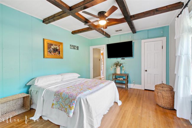 Bedroom with coffered ceiling, light wood-style floors, beamed ceiling, and baseboards | Image 18