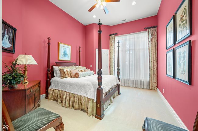 bedroom with visible vents, baseboards, a ceiling fan, and light carpet | Image 41