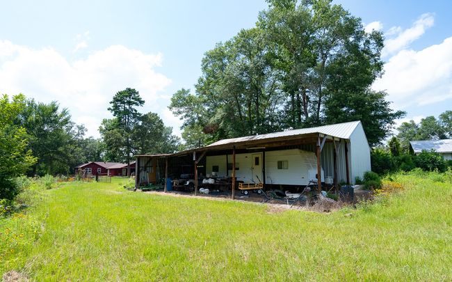 View of yard with a pole building, an outdoor structure, and a carport | Image 39