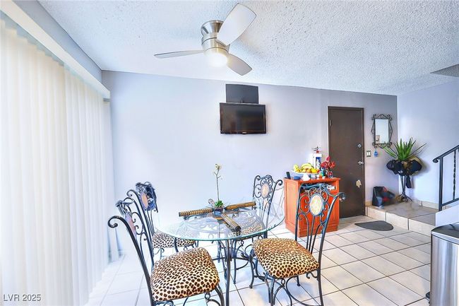 Dining area featuring ceiling fan, and tiled flooring | Image 6
