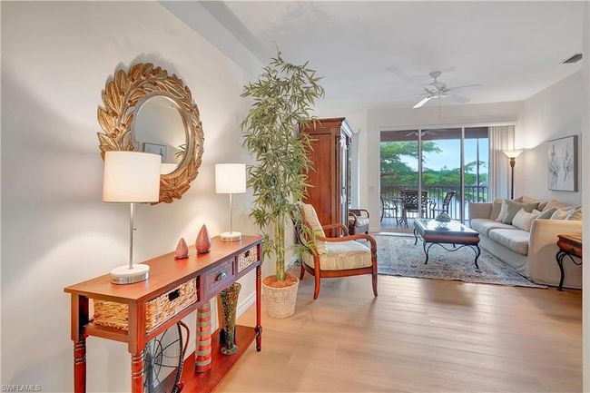 Living room featuring ceiling fan and light hardwood / wood-style flooring | Image 4