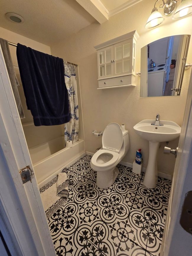 Full bath featuring tile patterned floors and shower / tub combo with curtain | Image 19