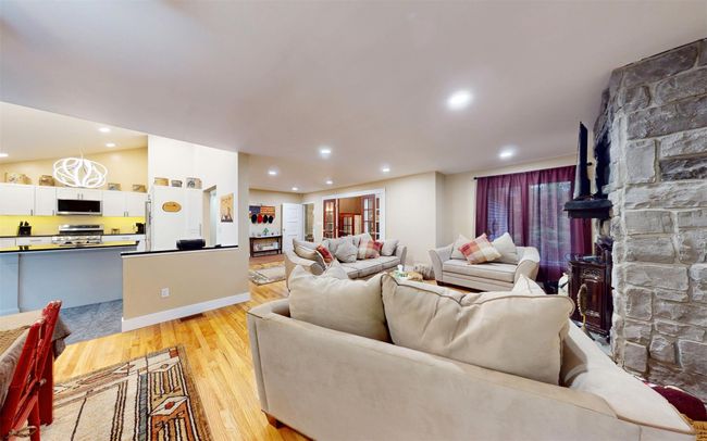 Living room featuring light wood finished floors, recessed lighting, and baseboards | Image 11