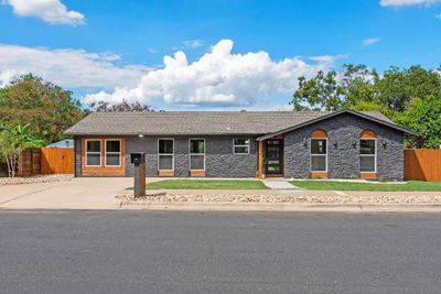 The front of the house features impressive curb appeal with charming cedar accents and meticulously maintained landscaping, creating a warm and inviting entrance. | Image 2