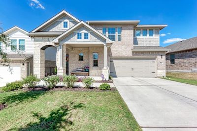 Expansive front porch with beautiful landscape + landscape lighting. | Image 2