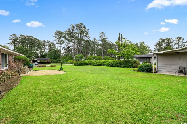View of yard with a patio and view of wooded area | Image 35