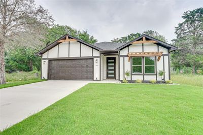 View of front of house featuring a garage and a front yard | Image 3