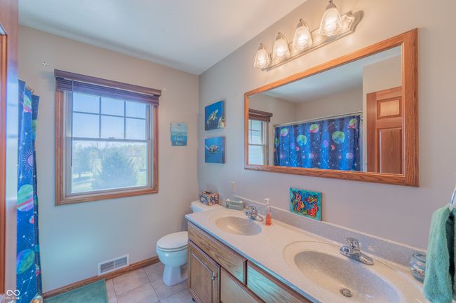full bath with tile patterned floors, visible vents, a sink, and double vanity | Image 25