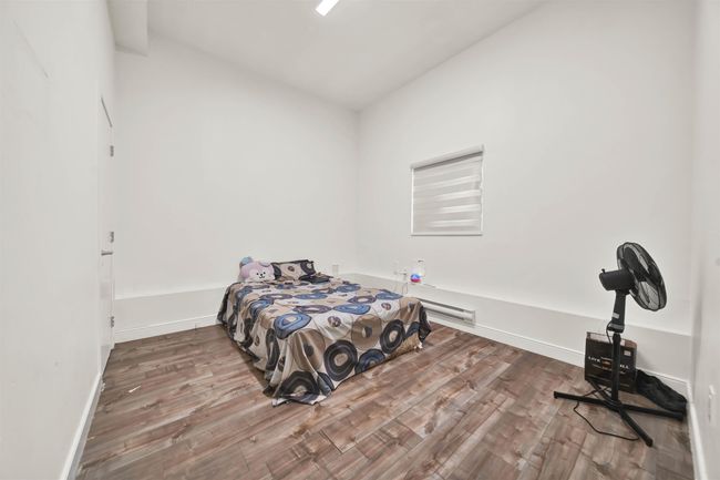 Bedroom featuring wood finished floors and baseboards | Image 15