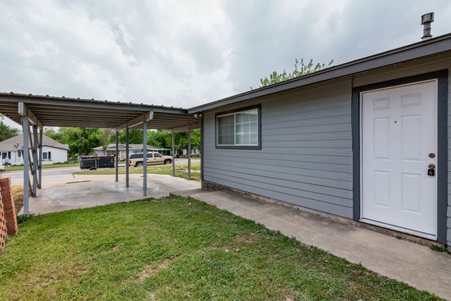 View of yard with a carport and a patio | Image 4