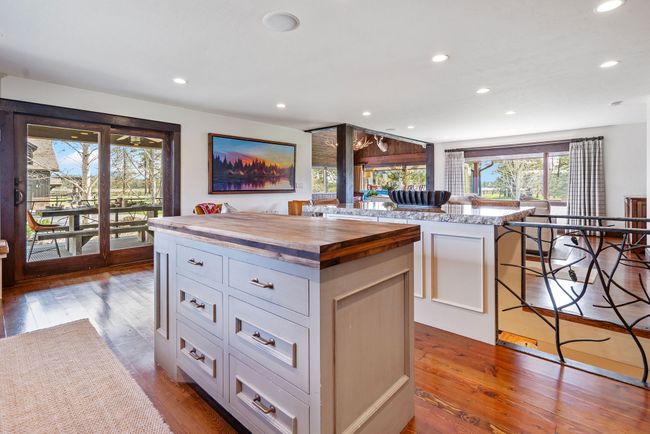 Kitchen with white cabinets, recessed lighting, butcher block countertops, and a kitchen island | Image 23